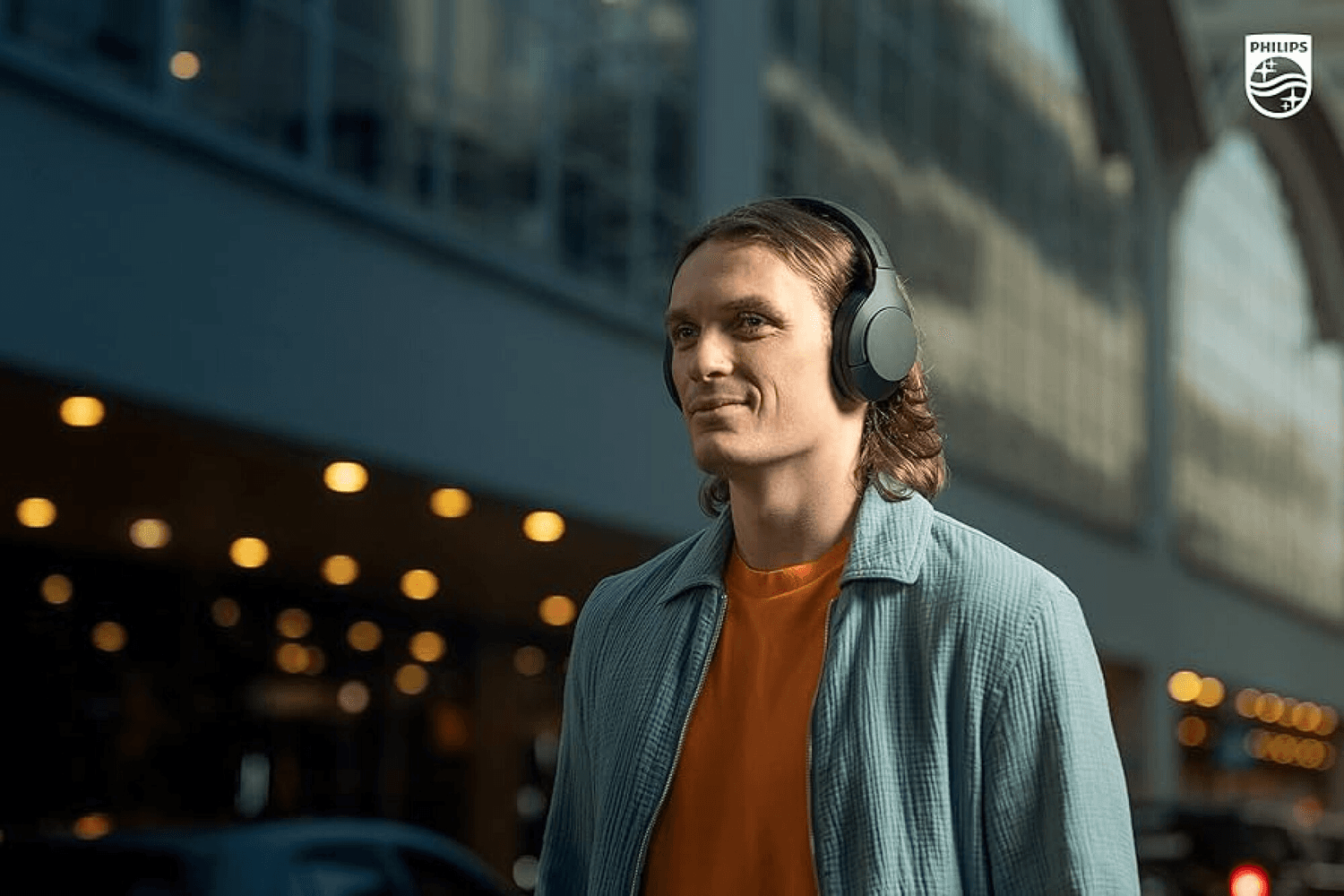Persona usando auriculares Philips TAH8506BK/00