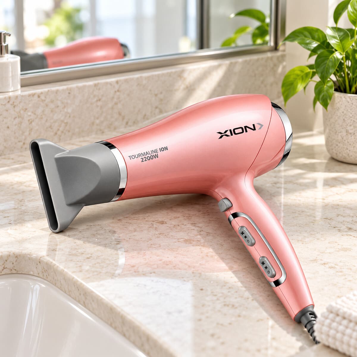 Secador de pelo XION XI-SE2205ION rosa sobre una mesada de baño
